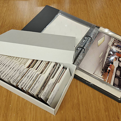 Archival photographs are placed in archival containers.